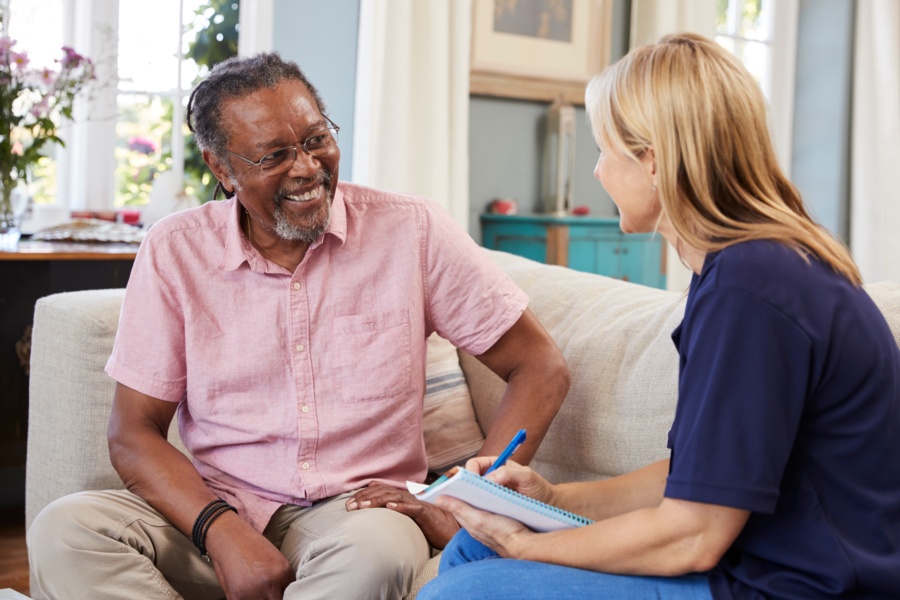 a young woman speaks with an older man as part of blended case management